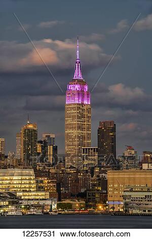 Empire State Building at sunset, colour honouring the Cupus Foundation of America; New York City, New York, United States of America View Large Photo Image Stock Image - Empire State Building at sunset, colour honouring the Cupus Foundation of America; New York City, New York, United States of America. Fotosearch