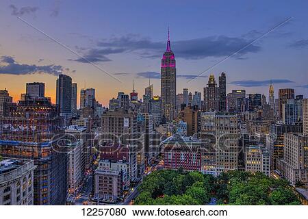 Stock Image - Empire State Building at sunset with colours honoring the Military Order of the Purple Heart; New York City, New York, United States of America. Fotosearch