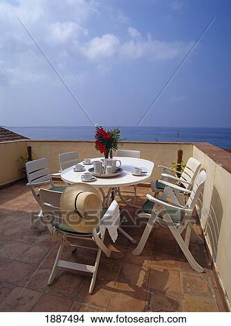 Empty Breakfast Table And Chairs On Balcony Overlooking The Ocean View Large Photo Image Picture - Empty Breakfast Table And Chairs On Balcony Overlooking The Ocean. Fotosearch