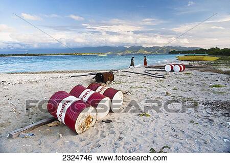Empty Oil Drums Litter The Beach, Gili Trawangan, Indonesia View Large Photo Image Stock Photograph - Empty Oil Drums Litter The Beach, Gili Trawangan, Indonesia. Fotosearch
