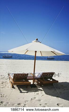 Empty Sun Loungers And Umbrella On Beach With Sea View View Large Photo Image Picture - Empty Sun Loungers And Umbrella On Beach With Sea View. Fotosearch