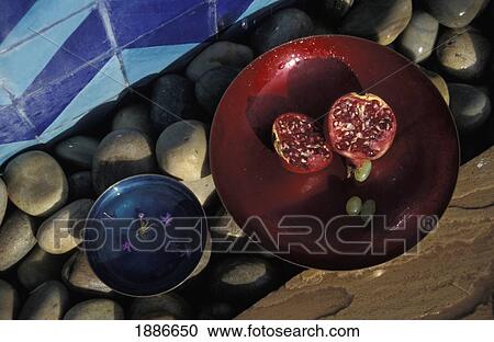 Stock Image - Enamel Finger Bowls With Pomegranate, Close Up. Fotosearch