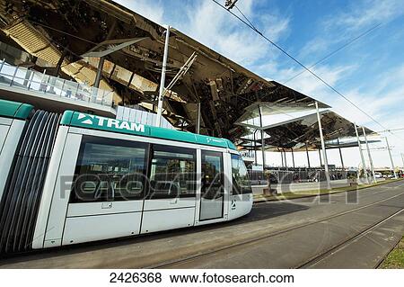 Stock Photo - Encants Nous de Barcelona and the light rail train in Poblenou neighbourhood; Barcelona, Catalonia, Spain. Fotosearch