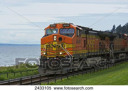 Stock Photography - Engine of orange-colored coastal train; White Rock, British Columbia, Canada. Fotosearch