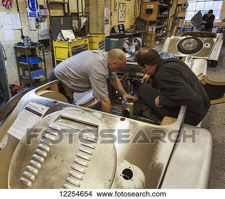 Engineers working on cars inside the Morgan Motor Car Company at Malvern Link; Malvern, Worcestershire, England View Large Photo Image Picture - Engineers working on cars inside the Morgan Motor Car Company at Malvern Link; Malvern, Worcestershire, England. Fotosearch