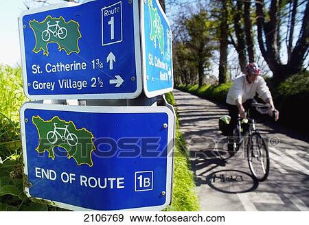 Stock Photo - England, Channel Islands, Cyclist on tourist route; Jersey. Fotosearch