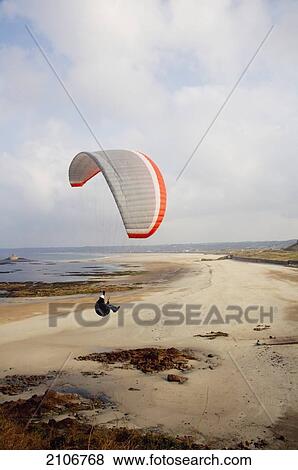 England, Channel Islands, Jersey, Paragliding over empty beach; St Quen's Bay View Large Photo Image Stock Photo - England, Channel Islands, Jersey, Paragliding over empty beach; St Quen's Bay. Fotosearch