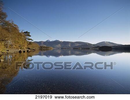 England, Cumbria, Calm waters of Derwent Water shortly after dawn; Lake District View Large Photo Image Stock Photo - England, Cumbria, Calm waters of Derwent Water shortly after dawn; Lake District. Fotosearch