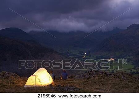 England, Cumbria, Lit tent on hill above Langdale on stormy evening; Lake District View Large Photo Image Stock Photograph - England, Cumbria, Lit tent on hill above Langdale on stormy evening; Lake District. Fotosearch
