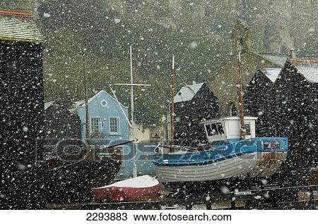Stock Image - England, East Sussex, Fishing boats covered with snow in old town; Hastings. Fotosearch