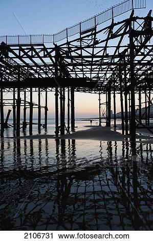 Stock Image - England, East Sussex, Ruins of Hastings pier on winter's evening; Hastings. Fotosearch
