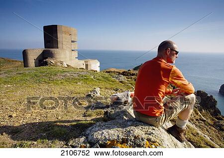 England, L'Angle tower; Guernsey, Tourist looking at seascape View Large Photo Image Stock Image - England, L'Angle tower; Guernsey, Tourist looking at seascape. Fotosearch