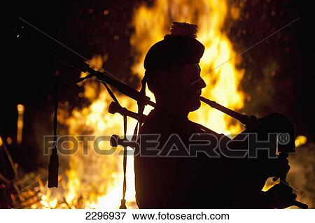 England, Silhouette of bagpiper in front of bonfire at Battle Bonfire night; East Sussex View Large Photo Image Stock Photo - England, Silhouette of bagpiper in front of bonfire at Battle Bonfire night; East Sussex. Fotosearch