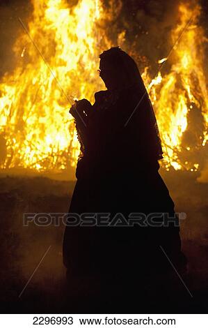 Stock Image - England, Woman dressed as Queen Victoria in front of bonfire at Battle Bonfire night; East Sussex. Fotosearch