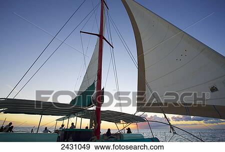 Stock Photo - Enjoying a sailboat ride on the Indian Ocean at sunset; Mauritius. Fotosearch