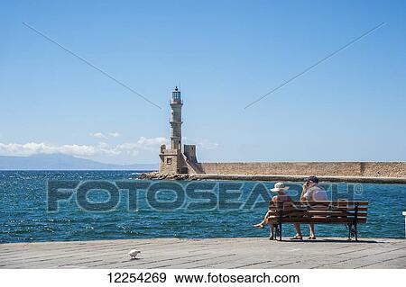 Enjoying the waterfront in Venetian harbour; Chania, Crete, Greece View Large Photo Image Stock Photo - Enjoying the waterfront in Venetian harbour; Chania, Crete, Greece. Fotosearch