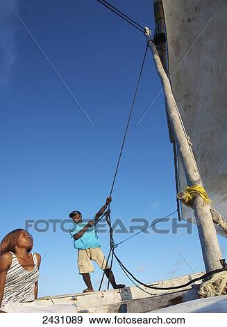 Stock Photo - Enjoying time on a sailboat; Vamizi Island, Mozambique. Fotosearch
