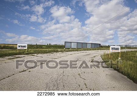 Stock Photography - Entrance To A Bleak, Abandoned Lot; Winnipeg, Manitoba, Canada. Fotosearch