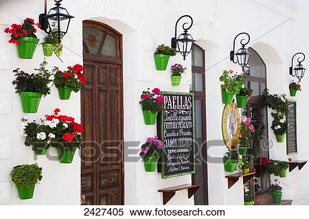 Entrance to a restaurant with flower pots mounted to the wall; Tarifa, Cadiz, Andalusia, Spain View Large Photo Image Stock Photography - Entrance to a restaurant with flower pots mounted to the wall; Tarifa, Cadiz, Andalusia, Spain. Fotosearch
