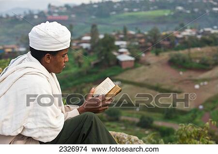 Picture - Ethiopia, Ethiopian Orthodox pilgrim reading The Bible; Lalibela. Fotosearch