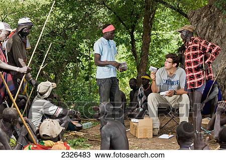 Ethiopia, South Western Ethiopia, Omo Valley, Southern Mursiland, View of archaeologist with Mursi people; Dirikoro View Large Photo Image Stock Image - Ethiopia, South Western Ethiopia, Omo Valley, Southern Mursiland, View of archaeologist with Mursi people; Dirikoro. Fotosearch