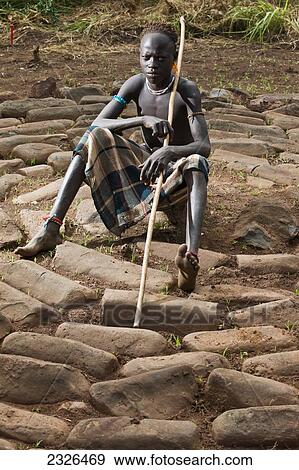 Stock Photo - Ethiopia, South Western Ethiopia, Omo Valley, Southern Mursiland, Portrait of Mursi boy; Dirikoro. Fotosearch
