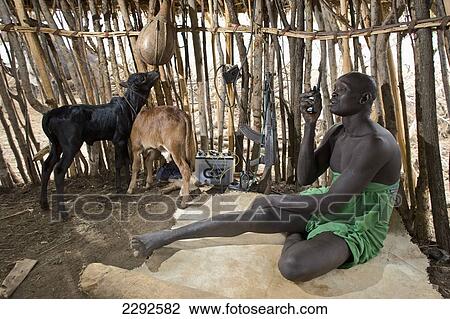 Ethiopia, Southern Nations Nationalities And Peoples' Region, South Omo, Mursi Tribal Man Using Walkie-Talkie; Southern Mursiland View Large Photo Image Stock Image - Ethiopia, Southern Nations Nationalities And Peoples' Region, South Omo, Mursi Tribal Man Using Walkie-Talkie; Southern Mursiland. Fotosearch