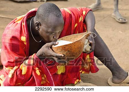 Ethiopia, Southern Nations Nationalities And Peoples' Region, South Omo, Mursiland, Mursi Tribal Man Eating; Maganto Village View Large Photo Image Stock Image - Ethiopia, Southern Nations Nationalities And Peoples' Region, South Omo, Mursiland, Mursi Tribal Man Eating; Maganto Village. Fotosearch