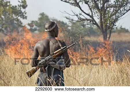 Ethiopia, Southern Nations Nationalities And Peoples' Region, South Omo, Rear View Of Mursi Tribal Man Looking At Controlled Fire On Savanah; Southern Mursiland View Large Photo Image Stock Image - Ethiopia, Southern Nations Nationalities And Peoples' Region, South Omo, Rear View Of Mursi Tribal Man Looking At Controlled Fire On Savanah; Southern Mursiland. Fotosearch