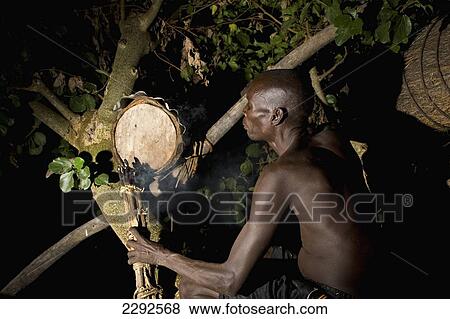 Ethiopia, Southern Nations Nationalities And Peoples' Region, South Omo, Mursiland, Mursi Tribal Man Smoking Beehive High Up In Tree At Night To Collecting Honey; Makki Village View Large Photo Image Stock Photo - Ethiopia, Southern Nations Nationalities And Peoples' Region, South Omo, Mursiland, Mursi Tribal Man Smoking Beehive High Up In Tree At Night To Collecting Honey; Makki Village. Fotosearch
