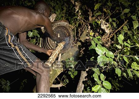 Ethiopia, Southern Nations Nationalities And Peoples' Region, South Omo, Mursiland, Mursi Tribal Man Smoking Beehive High Up In Tree At Night To Collecting Honey; Makki Village View Large Photo Image Stock Photography - Ethiopia, Southern Nations Nationalities And Peoples' Region, South Omo, Mursiland, Mursi Tribal Man Smoking Beehive High Up In Tree At Night To Collecting Honey; Makki Village. Fotosearch