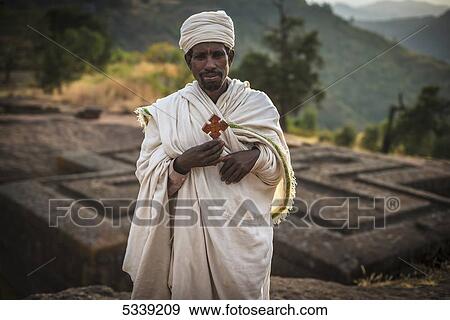 Stock Photo - Ethiopian Orthodox Christian pilgrim with cross; Lalibela, Ethiopia. Fotosearch