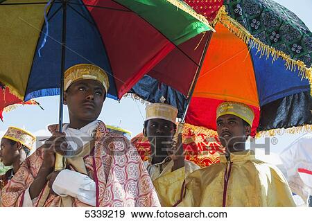 Ethiopian Orthodox Christian pilgrims with colourful umbrellas; Lalibela, Ethiopia View Large Photo Image Stock Photo - Ethiopian Orthodox Christian pilgrims with colourful umbrellas; Lalibela, Ethiopia. Fotosearch