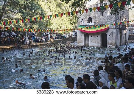 Ethiopian Orthodox Christians swimming in water at a rock-cut church at Timkat; Lalibela, Ethiopia View Large Photo Image Stock Image - Ethiopian Orthodox Christians swimming in water at a rock-cut church at Timkat; Lalibela, Ethiopia. Fotosearch