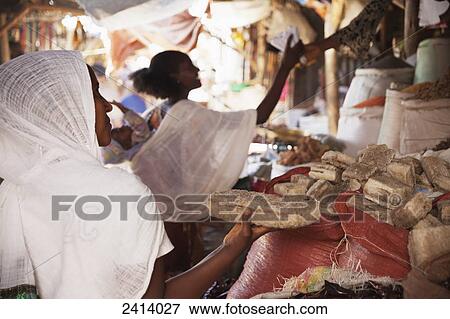 Ethiopian woman buying a block of salt at a local market; Mekele, Tigray region, Ethiopia View Large Photo Image Stock Photo - Ethiopian woman buying a block of salt at a local market; Mekele, Tigray region, Ethiopia. Fotosearch