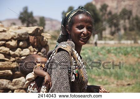 Ethiopian woman carrying baby; Gheralta, Tigray region, Ethiopia View Large Photo Image Stock Image - Ethiopian woman carrying baby; Gheralta, Tigray region, Ethiopia. Fotosearch