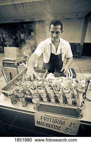Stock Image - Ethnic Food Cart With Vendor. Fotosearch