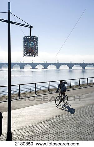 Stock Image - Europe, France, Bordeaux, riverside gironde cyclist. Fotosearch