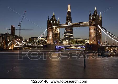 Stock Photograph - Evening view of Tower Bridge, the River Thames and the Shard building; London, England. Fotosearch
