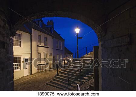 Stock Photography - Evening View Through Archway Of Houses In The Historic Town Of Whitby.. Fotosearch