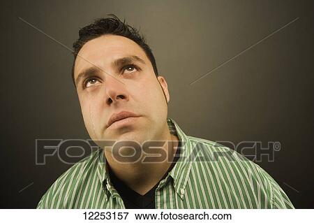 Stock Photo - Expressive portrait of a man; Edmonton, Alberta, Canada. Fotosearch