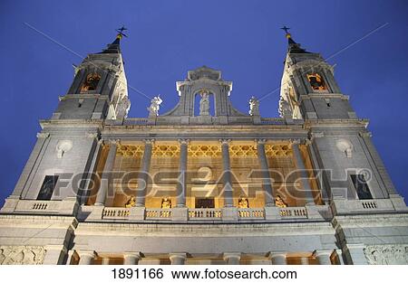 Stock Photograph - Exterior Of Almudena Cathedral Illuminated At Dusk. Fotosearch
