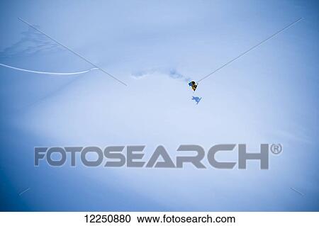 Stock Image - Extreme snowboarding on a snow covered slope; Haines, Alaska, United States of America. Fotosearch