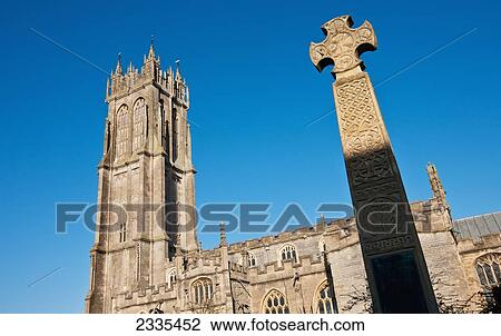 Stock Image - Facade Of Church With Cross On Monument; Glastonbury, Somerset, England. Fotosearch