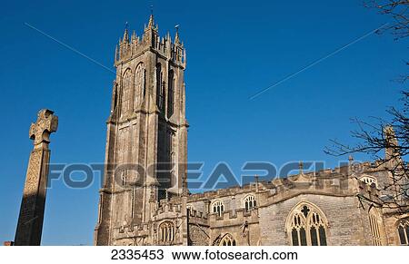 Stock Image - Facade Of Church With Cross On Monument; Glastonbury, Somerset, England. Fotosearch