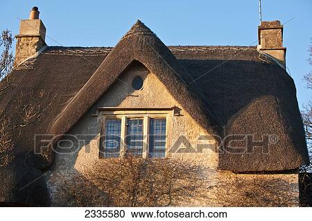 Stock Image - Facade Of Thatched Roof House; Wiltshire, England, Uk. Fotosearch