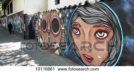 Faces painted on a wall lining a walkway; Santiago, Santiago Metropolitan Region, Chile View Large Photo Image Stock Image - Faces painted on a wall lining a walkway; Santiago, Santiago Metropolitan Region, Chile. Fotosearch