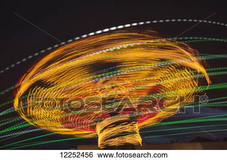 Stock Photograph - Fairground ride light effect at night; Calgary, Alberta, Canada. Fotosearch