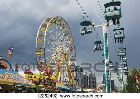 Stock Image - Fairground rides at the Calgary Stampede; Calgary, Alberta, Canada. Fotosearch