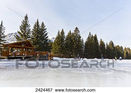 Families skating on outdoor rink; Canmore, Alberta, Canada View Large Photo Image Stock Photo - Families skating on outdoor rink; Canmore, Alberta, Canada. Fotosearch
